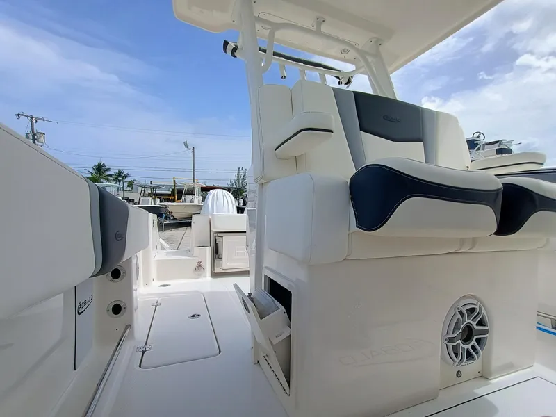 Slide: The Image of 2025 Robalo R270 Center Console boat interior with cushioned seating and speaker system. - 19