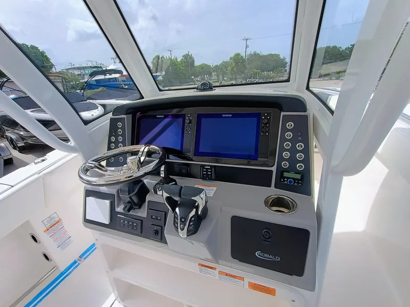 Slide: The Image of 2025 Robalo R270 Center Console helm with dual displays and modern controls. - 20