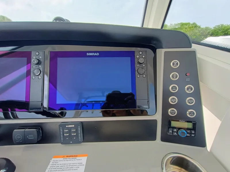 Slide: The Image of 2025 Robalo R270 Center Console dashboard with Simrad displays and control panel. - 22