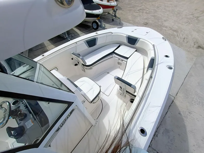 Slide: The Image of 2025 Robalo R270 Center Console boat interior with seating and console view. - 29