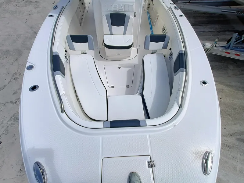 Slide: The Image of 2025 Robalo R270 Center Console boat interior with cushioned seating and storage compartments. - 31