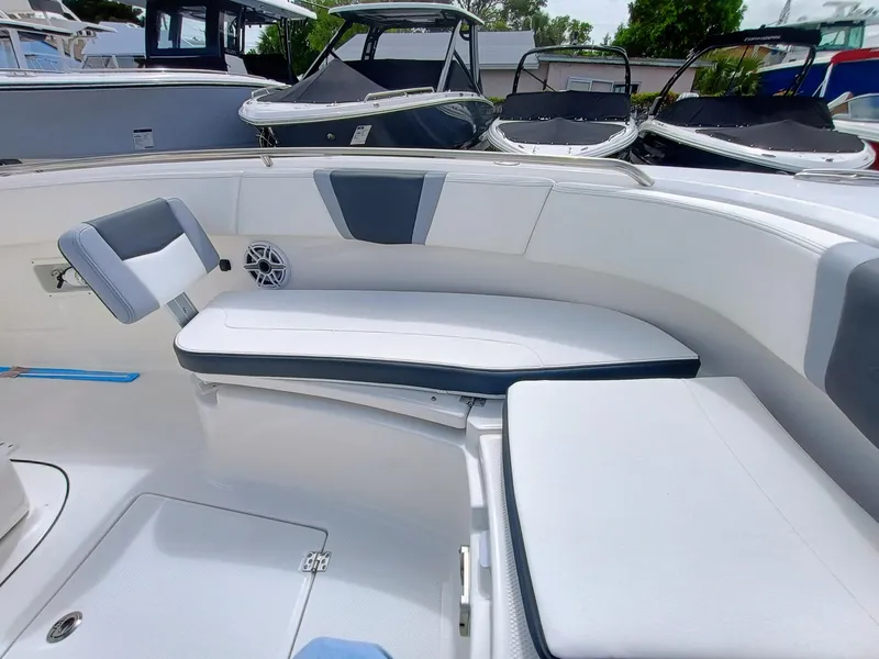 Slide: The Image of 2025 Robalo R270 Center Console boat interior with cushioned seating and modern design. - 32