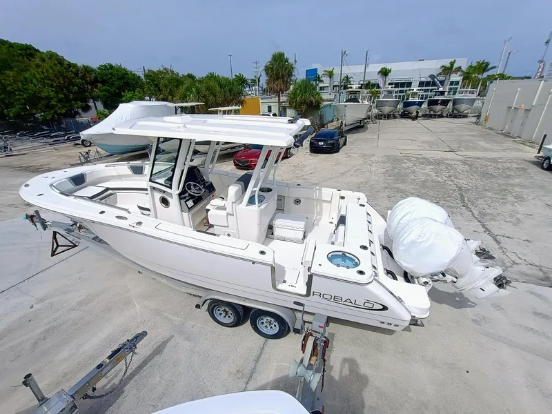 Slide: The Image of 2025 Robalo R270 Center Console boat on trailer in marina setting. - 4
