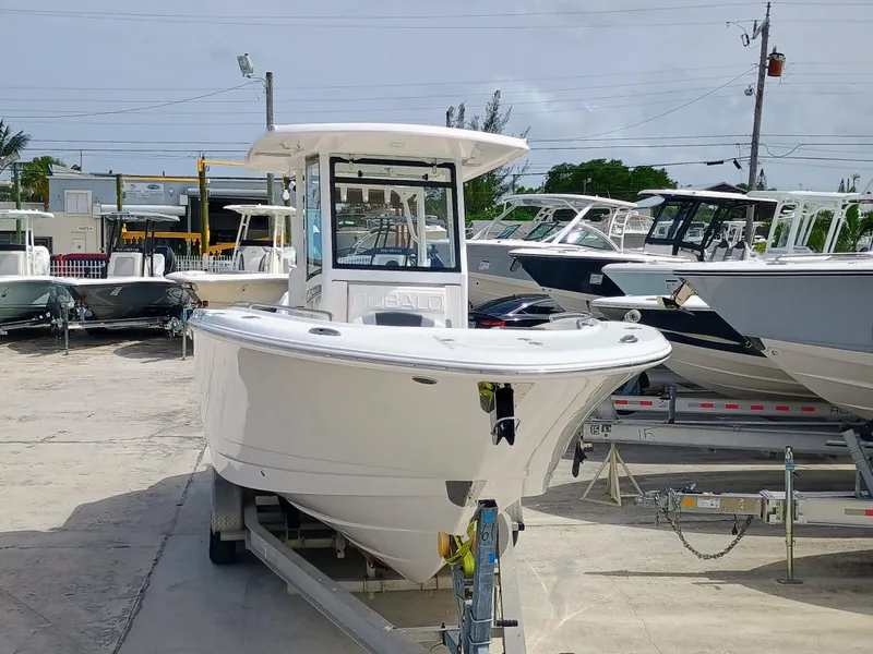 Slide: The Image of 2025 Robalo R270 Center Console boat on trailer in marina setting. - 6