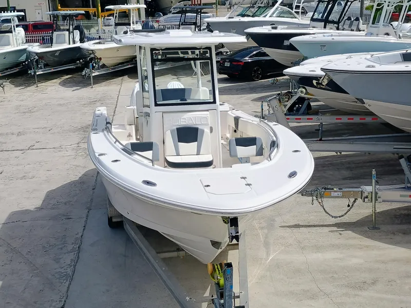 Slide: The Image of 2025 Robalo R270 Center Console boat on trailer in marina setting. - 8