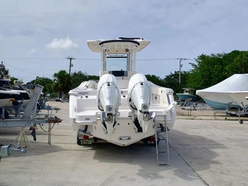 Slide: The Image of 2025 Robalo R270 Center Console boat with dual outboard engines on a trailer. - 9