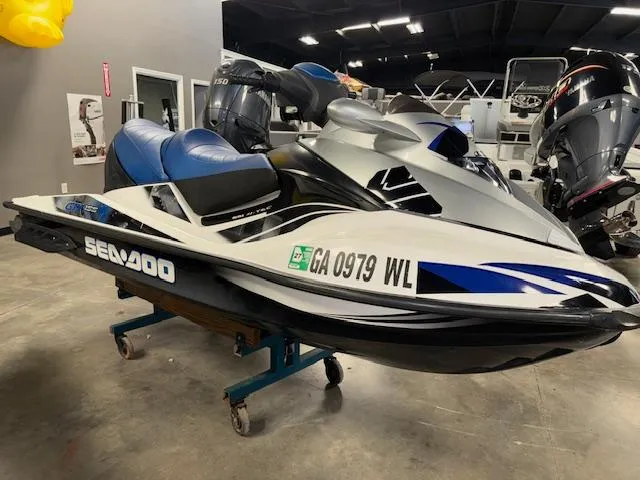 The Image of 2008 Sea-Doo GTX 155 jet ski in showroom, blue and white design. - 1