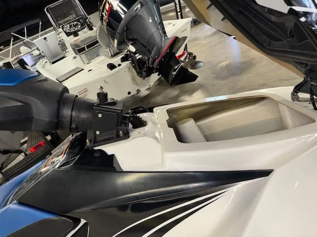 Slide: The Image of 2008 Sea-Doo GTX 155 jet ski with open storage compartment in a showroom. - 10