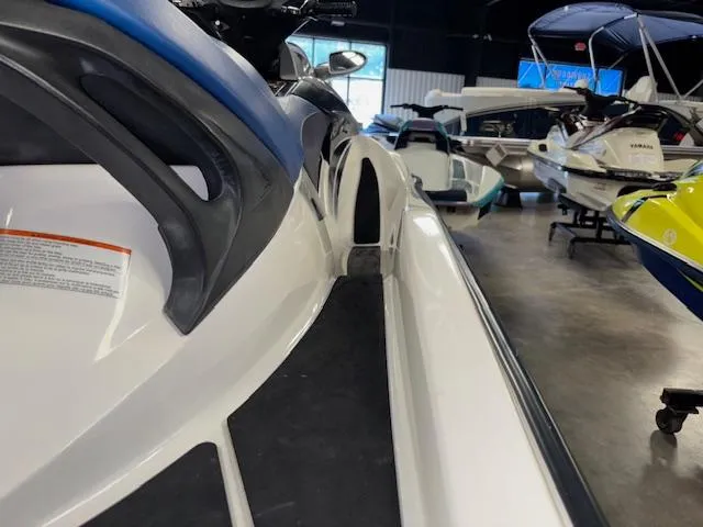 Slide: The Image of 2008 Sea-Doo GTX 155 jet ski in showroom, surrounded by various watercraft. - 14