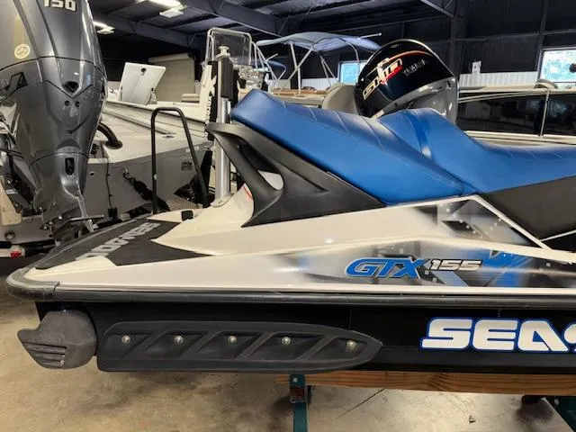 Slide: The Image of 2008 Sea-Doo GTX 155 jet ski with blue seat in a showroom. - 15