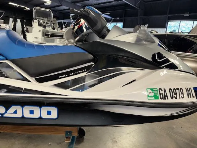 Slide: The Image of 2008 Sea-Doo GTX 155 jet ski with blue seat in a showroom. - 16