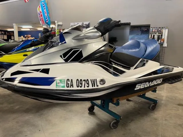 Slide: The Image of 2008 Sea-Doo GTX 155 jet ski in showroom, silver and blue design, displayed on a stand. - 3
