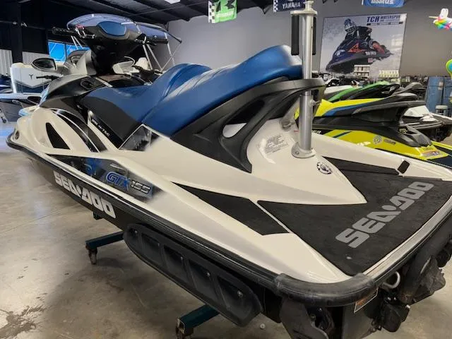 Slide: The Image of 2008 Sea-Doo GTX 155 jet ski with blue seat in showroom. - 6