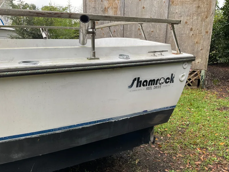 Slide: The Image of 1978 Shamrock 200 cc boat with keel drive, parked on grass. - 2