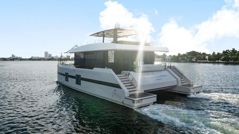 Slide: The Image of Luxurious 2018 Sunreef 70 yacht cruising on a sunny day, showcasing sleek design. - 11