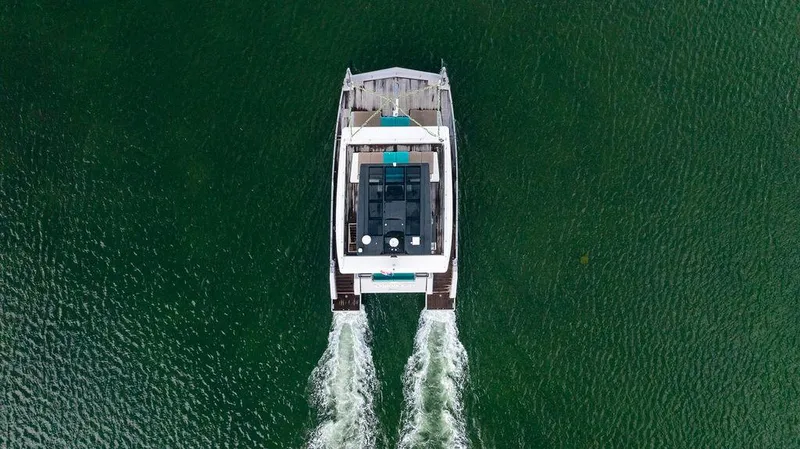 Slide: The Image of Aerial view of 2018 Sunreef 70 catamaran cruising on green water. - 15