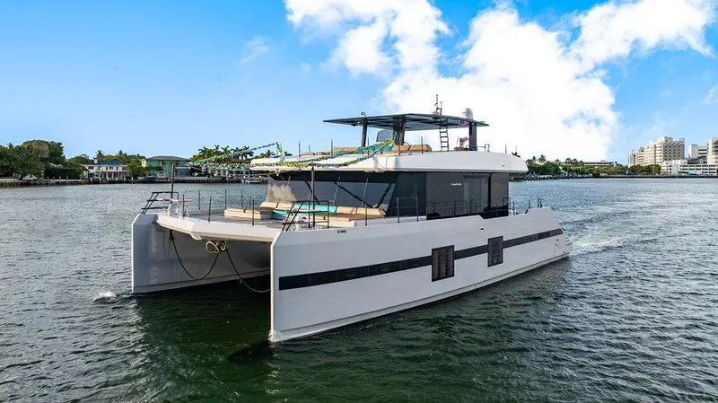 Slide: The Image of Luxurious 2018 Sunreef 70 yacht cruising on a sunny day, showcasing sleek design and spacious deck. - 2