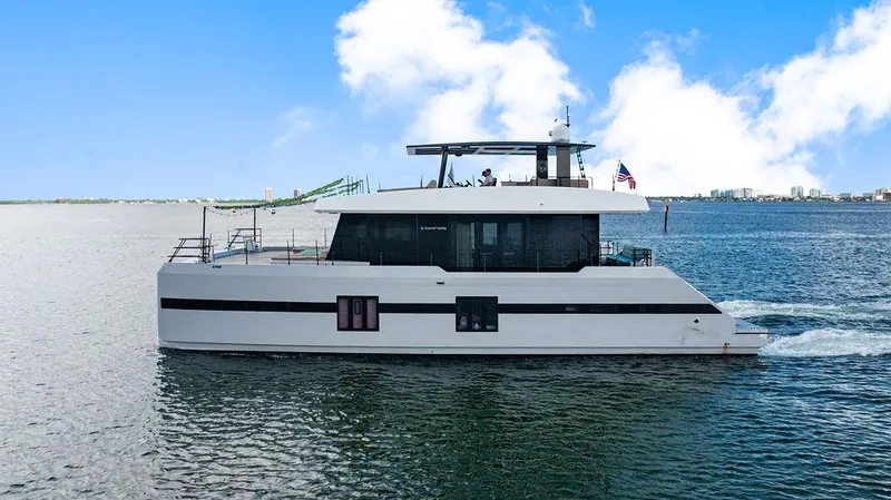 Slide: The Image of Luxury Sunreef 70 yacht cruising on open water, 2018 model, under clear blue skies. - 20