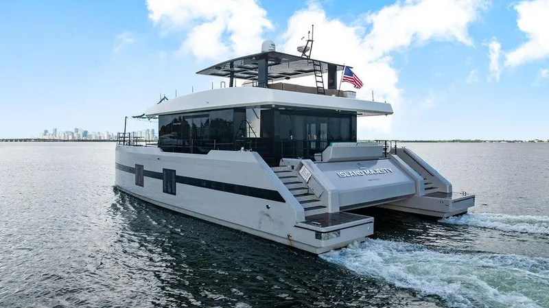 Slide: The Image of Luxurious 2018 Sunreef 70 yacht cruising on open water with city skyline in background. - 21