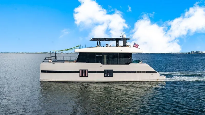 Slide: The Image of Luxurious 2018 Sunreef 70 yacht cruising on a sunny day with clear blue skies. - 23