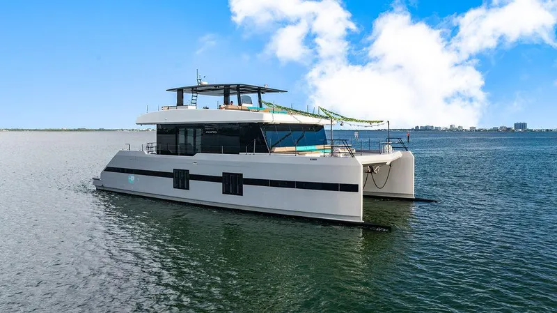 Slide: The Image of Luxurious 2018 Sunreef 70 catamaran on calm waters under a clear blue sky. - 31