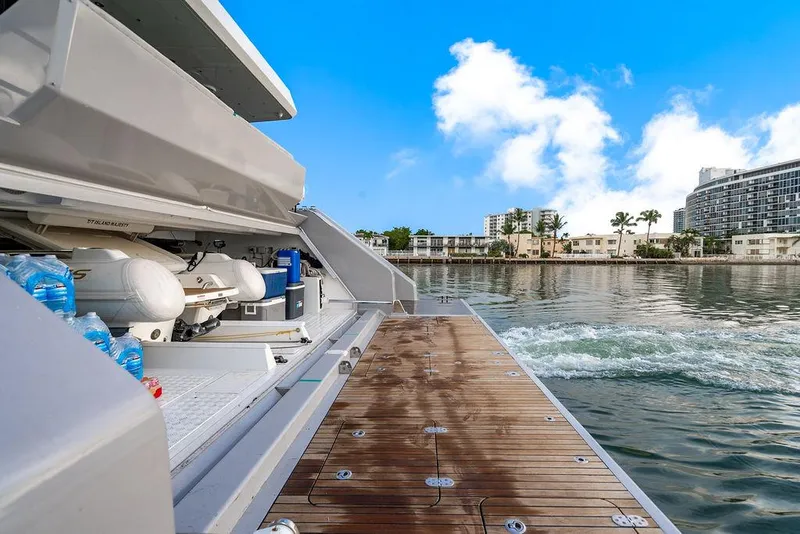 Slide: The Image of Luxury Sunreef 70 yacht deck with water view, 2018 model, docked near waterfront buildings. - 36