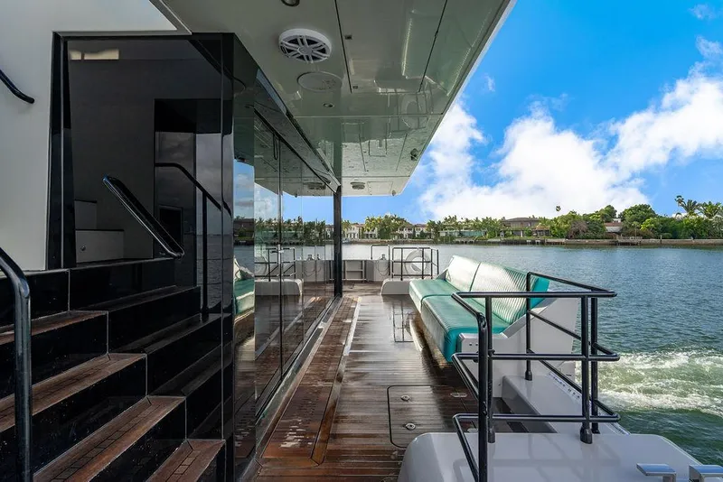 Slide: The Image of Luxurious Sunreef 70 yacht deck with seating, overlooking serene waters, 2018 model. - 38