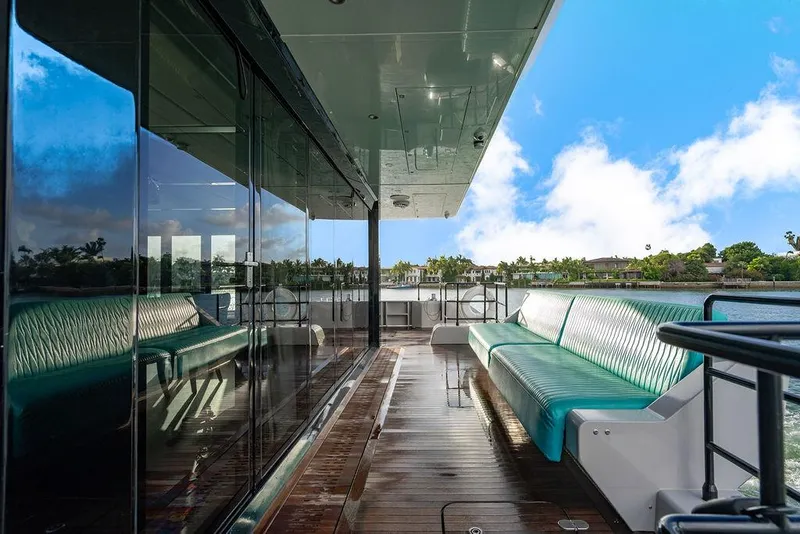 Slide: The Image of Luxurious Sunreef 70 yacht deck with turquoise seating, reflecting serene waterfront views. - 39