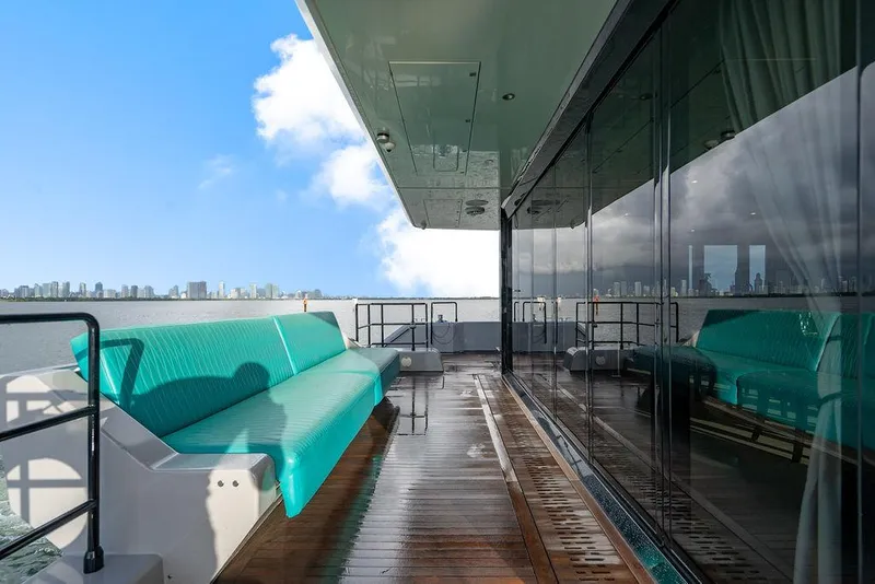 Slide: The Image of Luxurious Sunreef 70 yacht deck with turquoise seating, city skyline view, 2018 model. - 41