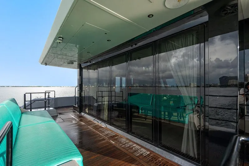 Slide: The Image of Luxurious Sunreef 70 yacht deck with turquoise seating, glass doors, and ocean view, 2018 model. - 44