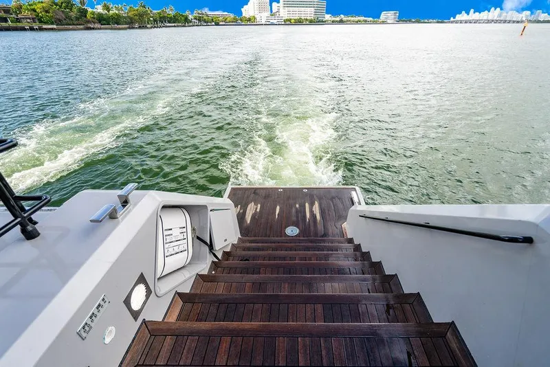 Slide: The Image of Stern view of 2018 Sunreef 70 yacht with wooden steps leading to water. - 45