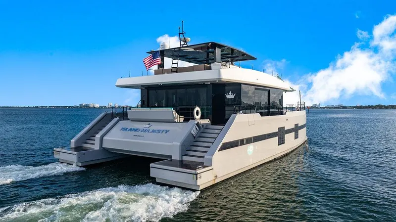 Slide: The Image of Luxury Sunreef 70 yacht cruising on open water, 2018 model, clear blue sky. - 9