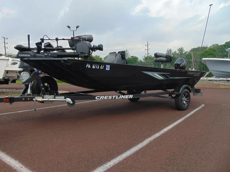 The Image of 2024 Crestliner 1700 Storm boat on trailer, equipped with Garmin technology. - 1