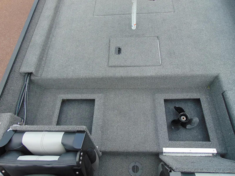 Slide: The Image of 2024 Crestliner 1700 Storm boat interior with carpeted deck and storage compartments. - 10