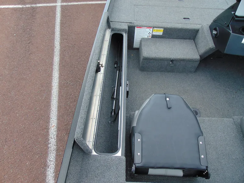 Slide: The Image of 2024 Crestliner 1700 Storm boat interior with storage compartment and seating. - 11