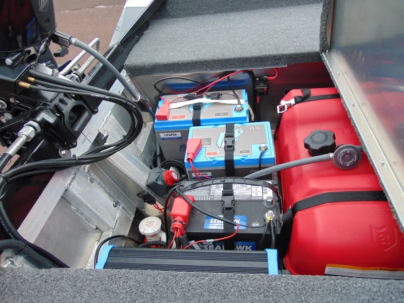 Slide: The Image of 2024 Crestliner 1700 Storm boat battery and fuel compartment with wiring and components. - 13