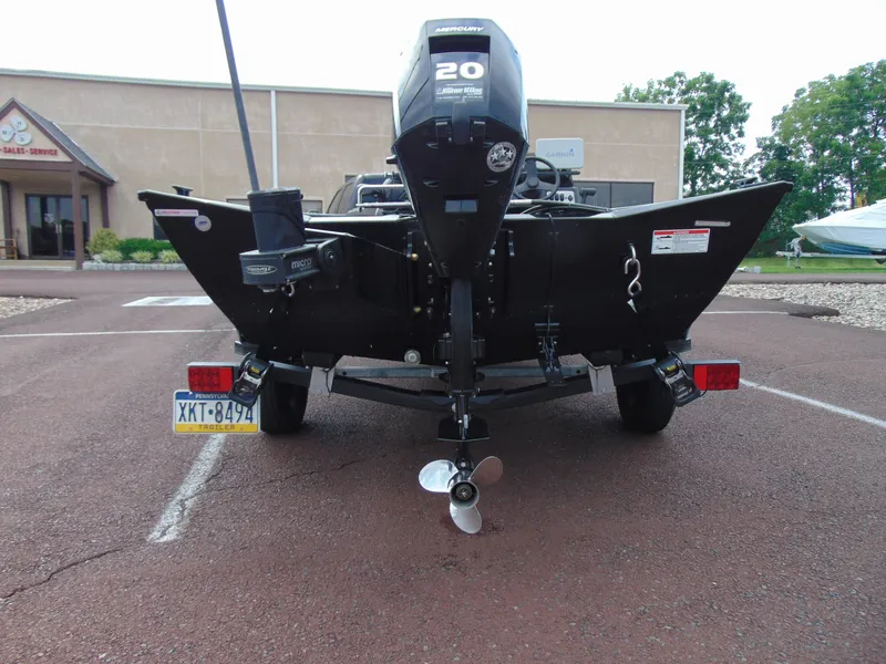 Slide: The Image of 2024 Crestliner 1700 Storm boat rear view with Mercury 20 engine in parking lot. - 14