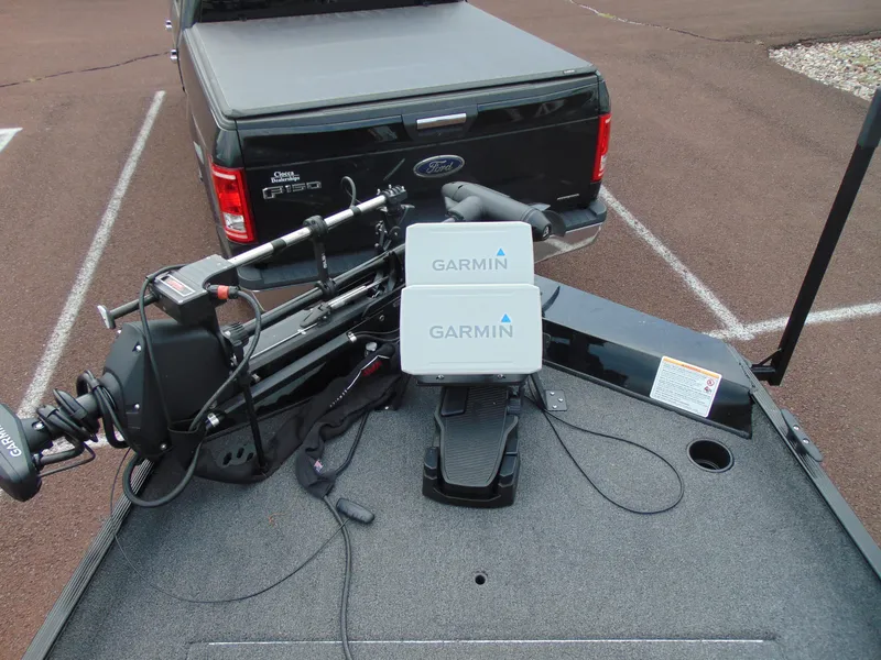 Slide: The Image of 2024 Crestliner 1700 Storm boat with Garmin equipment, parked behind a Ford F-150. - 4