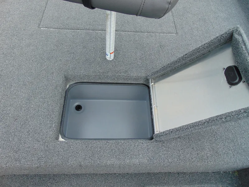 Slide: The Image of 2024 Crestliner 1700 Storm boat storage compartment with open lid, showcasing interior space. - 9