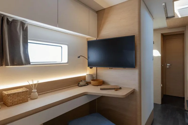 Slide: The Image of Modern interior of 2026 Fountaine Pajot 44 yacht with desk, TV, and window. - 35