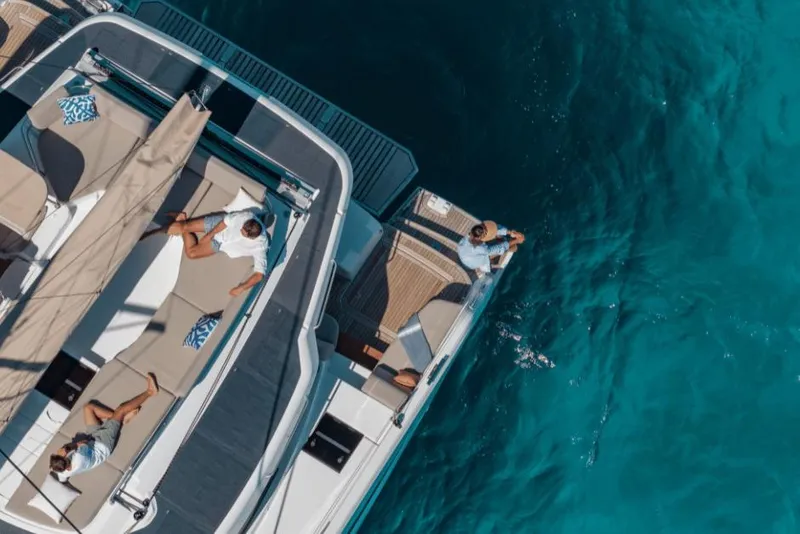 Slide: The Image of Aerial view of 2026 Fountaine Pajot 44 yacht with people relaxing on deck. - 36