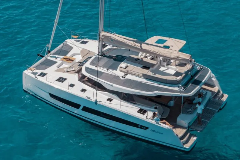 Slide: The Image of 2026 Fountaine Pajot 44 catamaran sailing on clear blue water. - 39