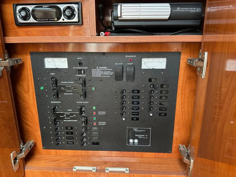 Slide: The Image of Control panel of a 2005 Rinker Fiesta Vee 300 boat with audio system and gauges. - 11