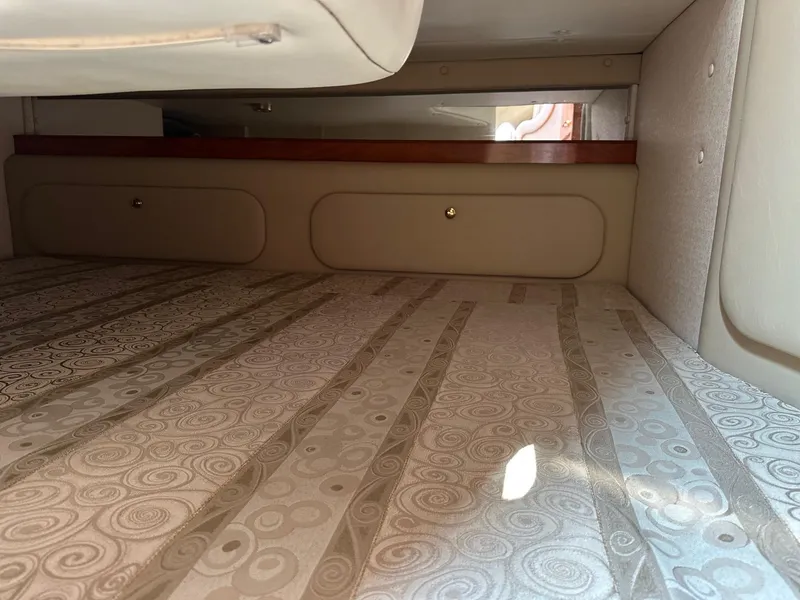 Slide: The Image of Interior cabin of 2005 Rinker Fiesta Vee 300 with patterned bedding. - 12