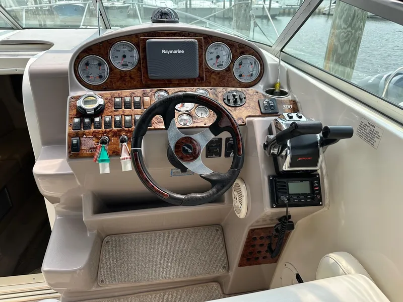 Slide: The Image of 2005 Rinker Fiesta Vee 300 helm with steering wheel, gauges, and control panel. - 3