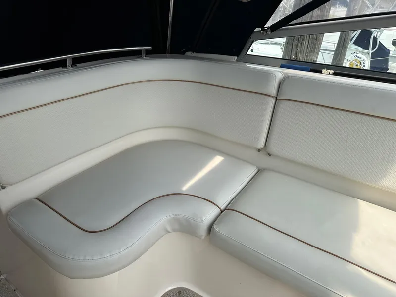 Slide: The Image of 2005 Rinker Fiesta Vee 300 boat interior with white cushioned seating. - 4