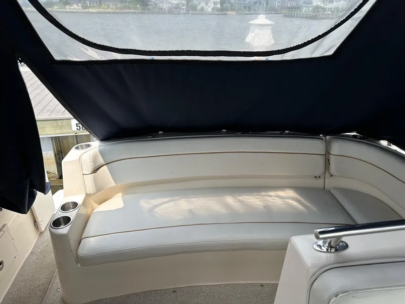 Slide: The Image of 2005 Rinker Fiesta Vee 300 boat interior with cushioned seating and cup holders. - 5