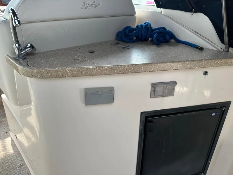 Slide: The Image of 2005 Rinker Fiesta Vee 300 boat interior with countertop, sink, and blue rope. - 6