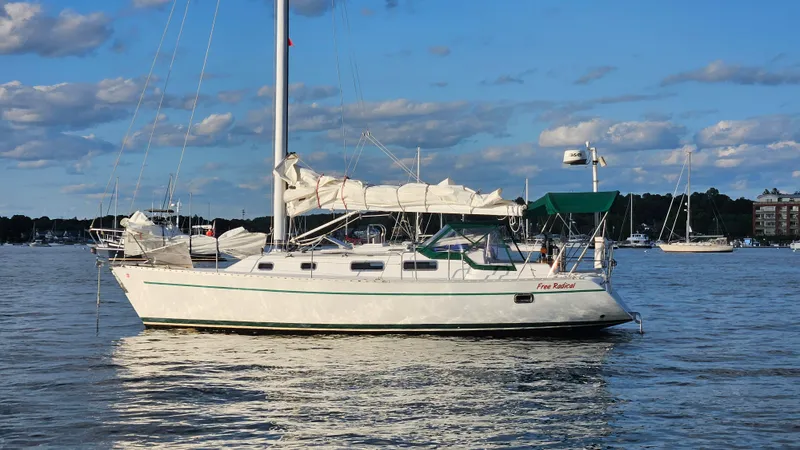 The Image of Sailboat "Free Radical" on calm water, Freedom 35 model, 1998, under a blue sky. - 0