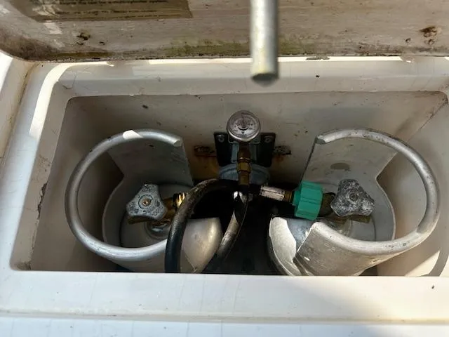Slide: The Image of Compartment with two propane tanks in a 1998 Freedom 35 boat. - 10